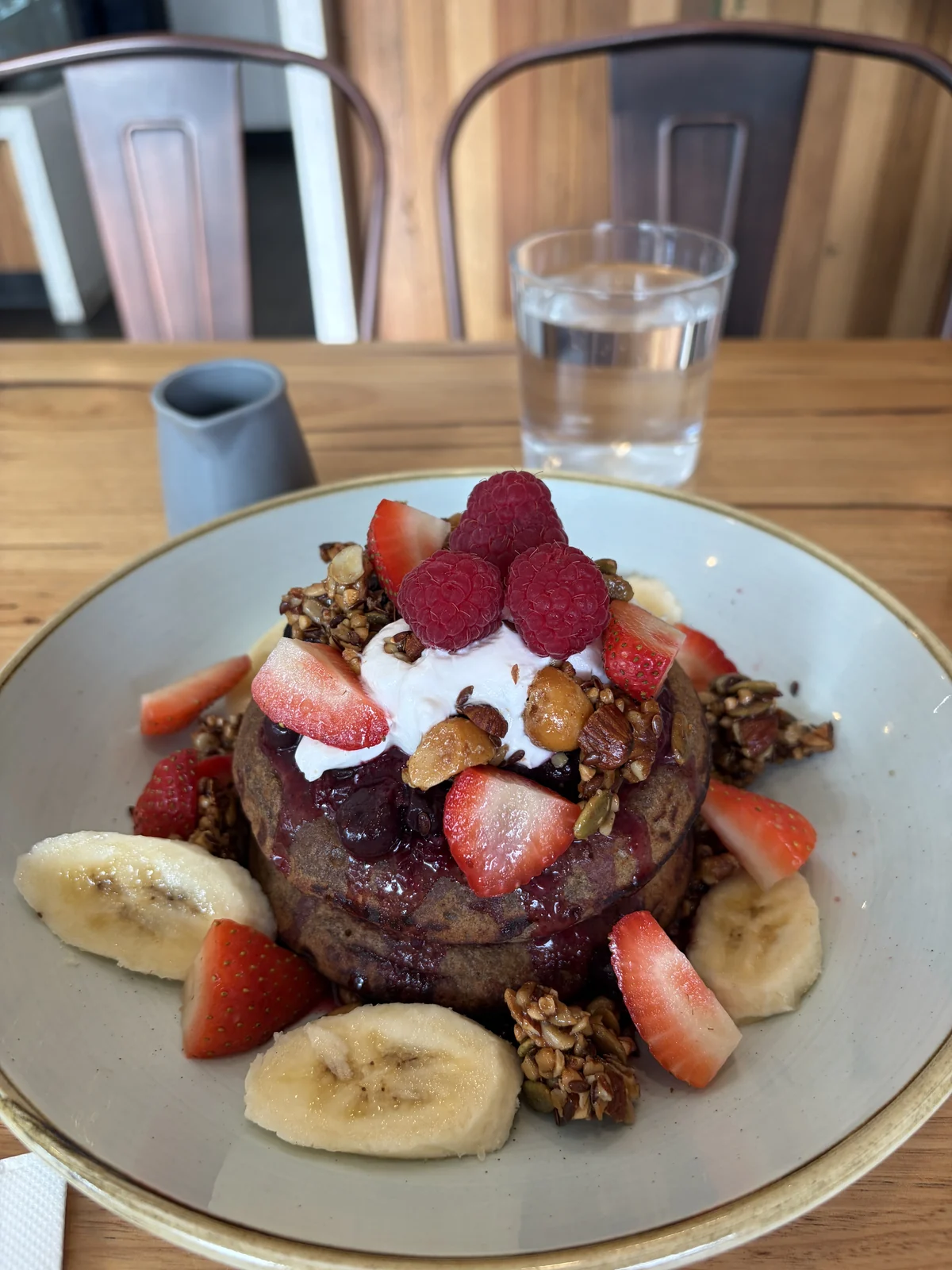 Gluten-free banana pancakes at Green Tree Cafe Elsternwick with berry compote, coconut yoghurt, granola, strawberries and banana
