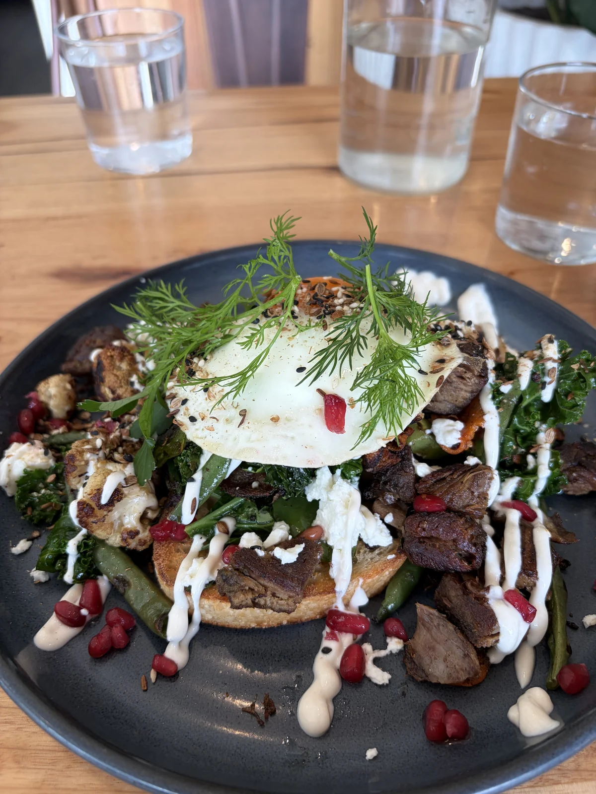 Bush lamb at Green Tree Cafe Elsternwick: sautéed lamb shoulder with kale, roasted cauliflower, goat cheese, pomegranate and tahini yoghurt on sourdough